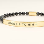 Close-up of the engraving: LOOK UP TO HIM with a cross
