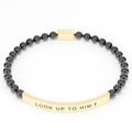 Look Up to Him cross bracelet in Black & Gold on white: black 4mm beads with a curved gold engraved bar